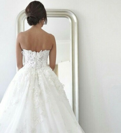 brown bun, white flower dress and white wedding dress