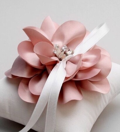 white pillow, wedding rings and simple and elegant