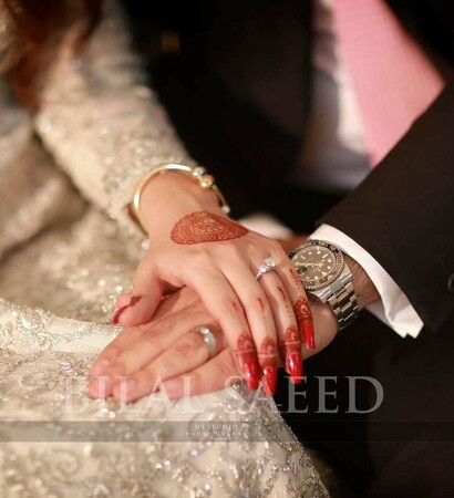 holding hand, mehendi and watch